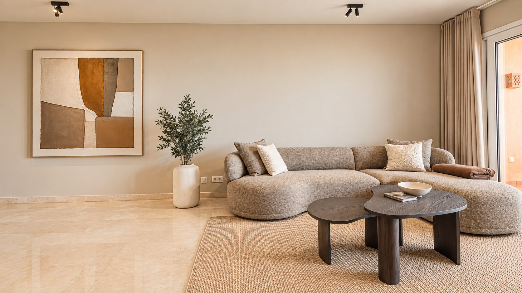 Warm beige living room with curved sofa and limestone floor