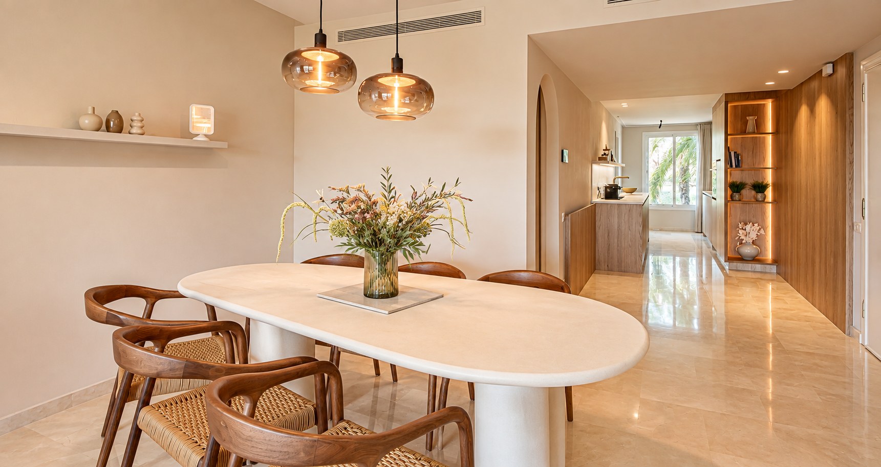 Warm beige dining room with limestone table and oak chairs
